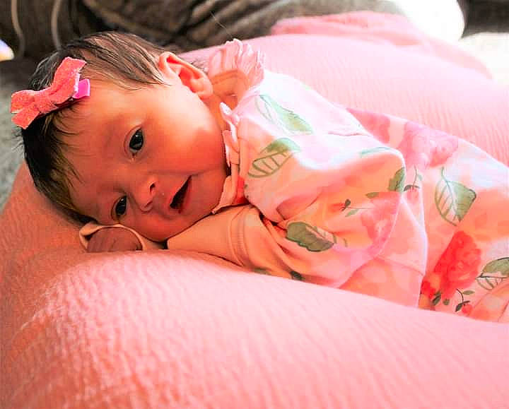 Alice joined the competition — help win amazing prizes! baby, baby_toddler_clothing, cheek, child, chin, comfort, dress, eyebrow, eyelash, grass, happy, iris, linens, lip, nose, orange, person, pink, sitting, skin