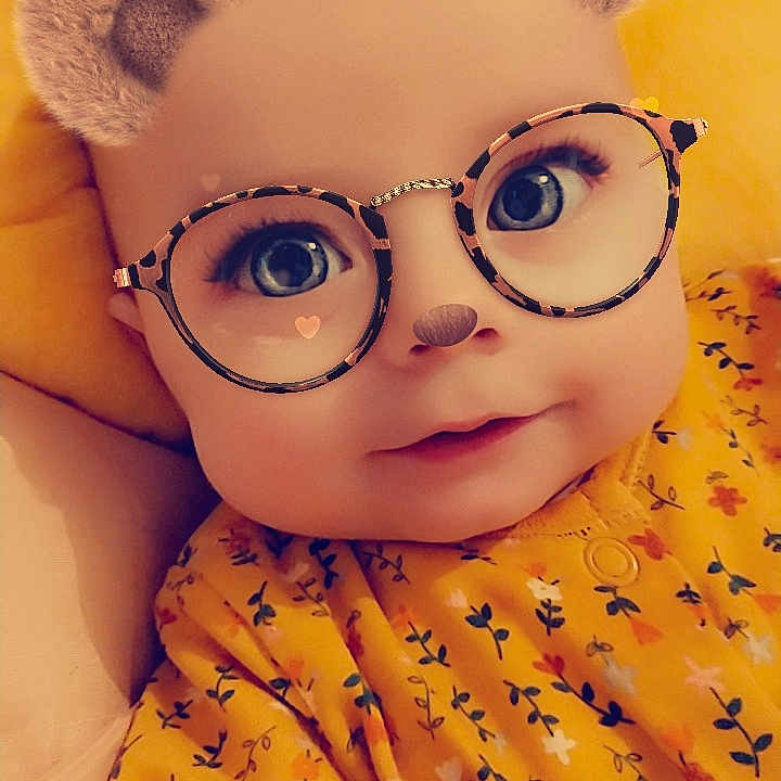 Emma-rose is registered to the contest to win money with this photo: baby, baby_toddler_clothing, cheek, chin, close_up, doll, eyebrow, eyelash, eyewear, face, glasses, happy, head, nose, orange, skin, sleeve, stuffed_toy, toy, vision_care