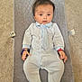 baby, infant, onesie, tie, baby_seat, carpet, bracelet, blue, white, striped, cute, child, portrait, laying_down, indoors, clothing, footed_pajamas, small_hands, curious, young