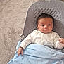 baby, infant, smiling, blanket, baby_seat, carpet, indoors, clothing, cute, face, person, child, happy, resting, cozy, home, soft, comfort, young, portrait