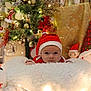 baby, christmas, holiday, santa_hat, plush, snowman, tree, decorations, lights, festive, blanket, indoors, cute, red, white, face, toy, seasonal, smile, child