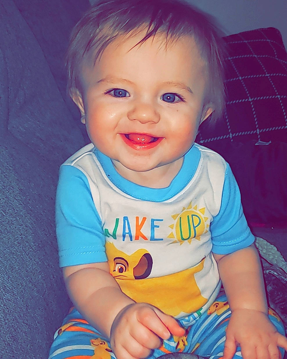 Lawrence is registered to the contest to win money with this photo: baby, baby_toddler_clothing, cheek, child, eye, face, facial_expression, iris, joy, lip, nose, person, play, sitting, skin, smile, toddler
