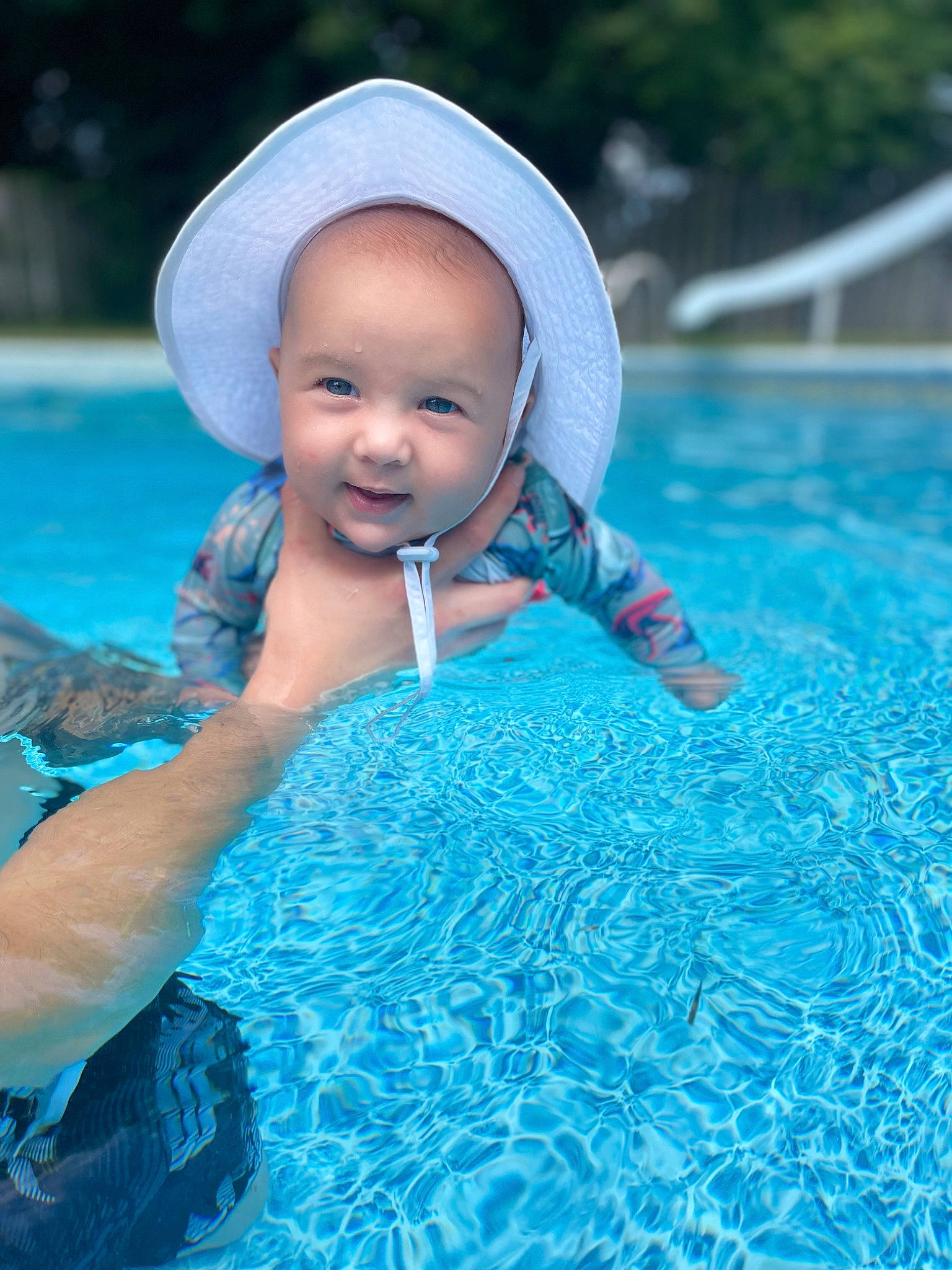 Damian is registered to the contest to win money with this photo: aqua, azure, baby, baby_products, baby_toddler_clothing, blue, child, electric_blue, fashion_accessory, fun, grass, happy, headgear, leisure, people_in_nature, person, recreation, smile, swimming_pool, toddler
