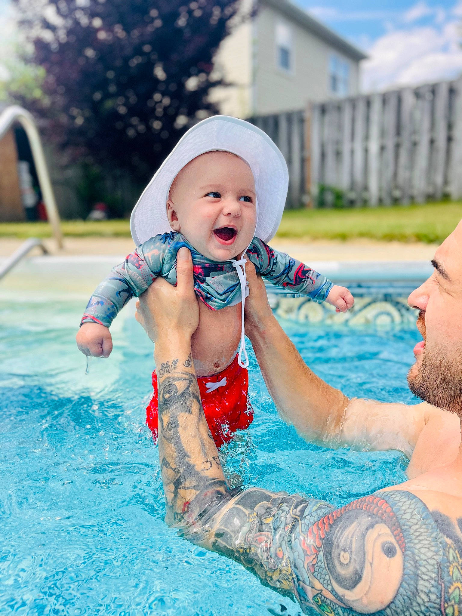 Damian is registered to the contest to win money with this photo: aqua, azure, baby, baby_toddler_clothing, beard, cap, child, event, fun, happy, hat, leisure, person, personal_protective_equipment, recreation, smile, summer, sun_hat, swimming_pool, toddler