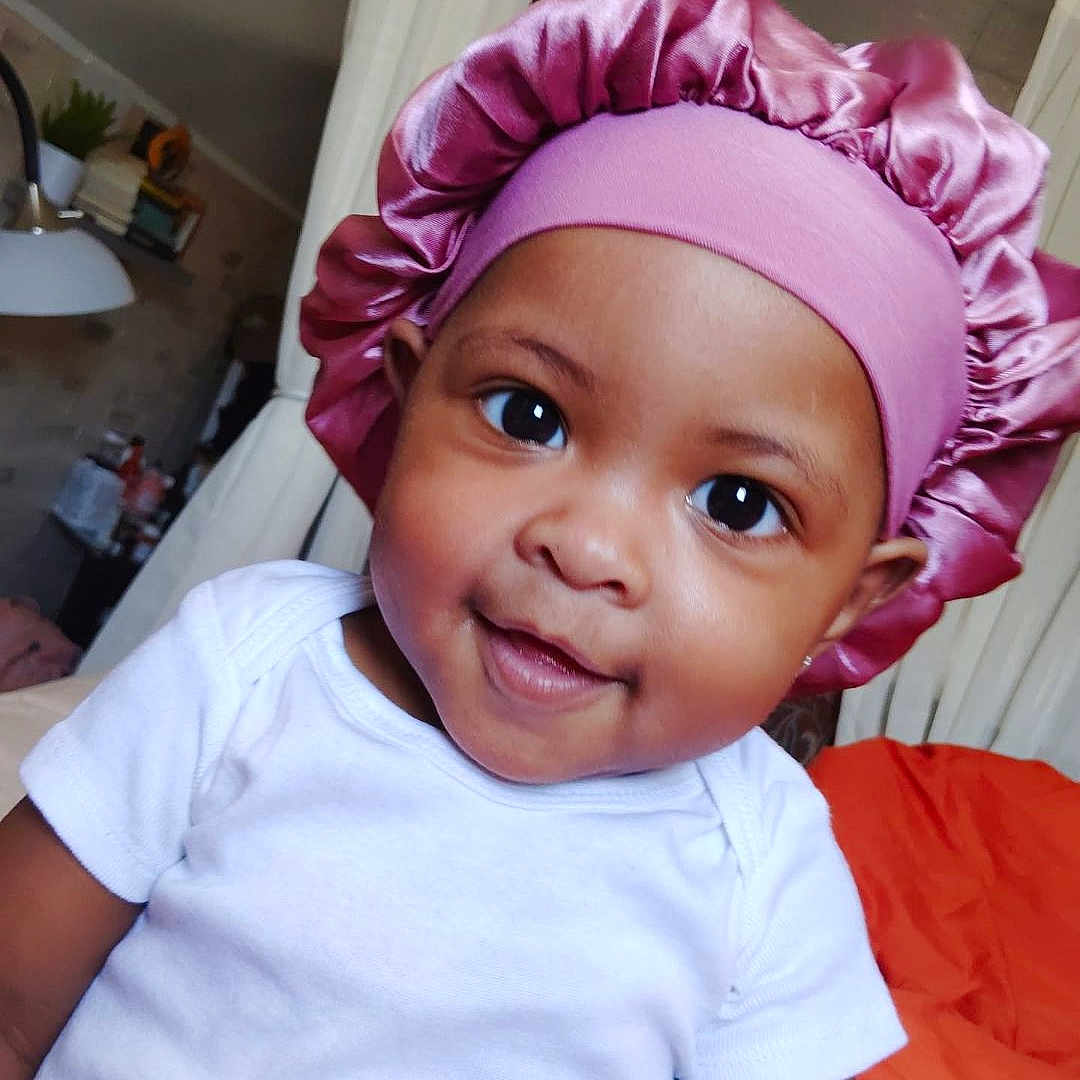 Ny'Omi is registered to the contest to win money with this photo: baby, bed, bedroom, bonnet, cap, clothing, costume, door, face, furniture, happy, hat, head, indoors, person, photography, portrait, room, smile, t_shirt