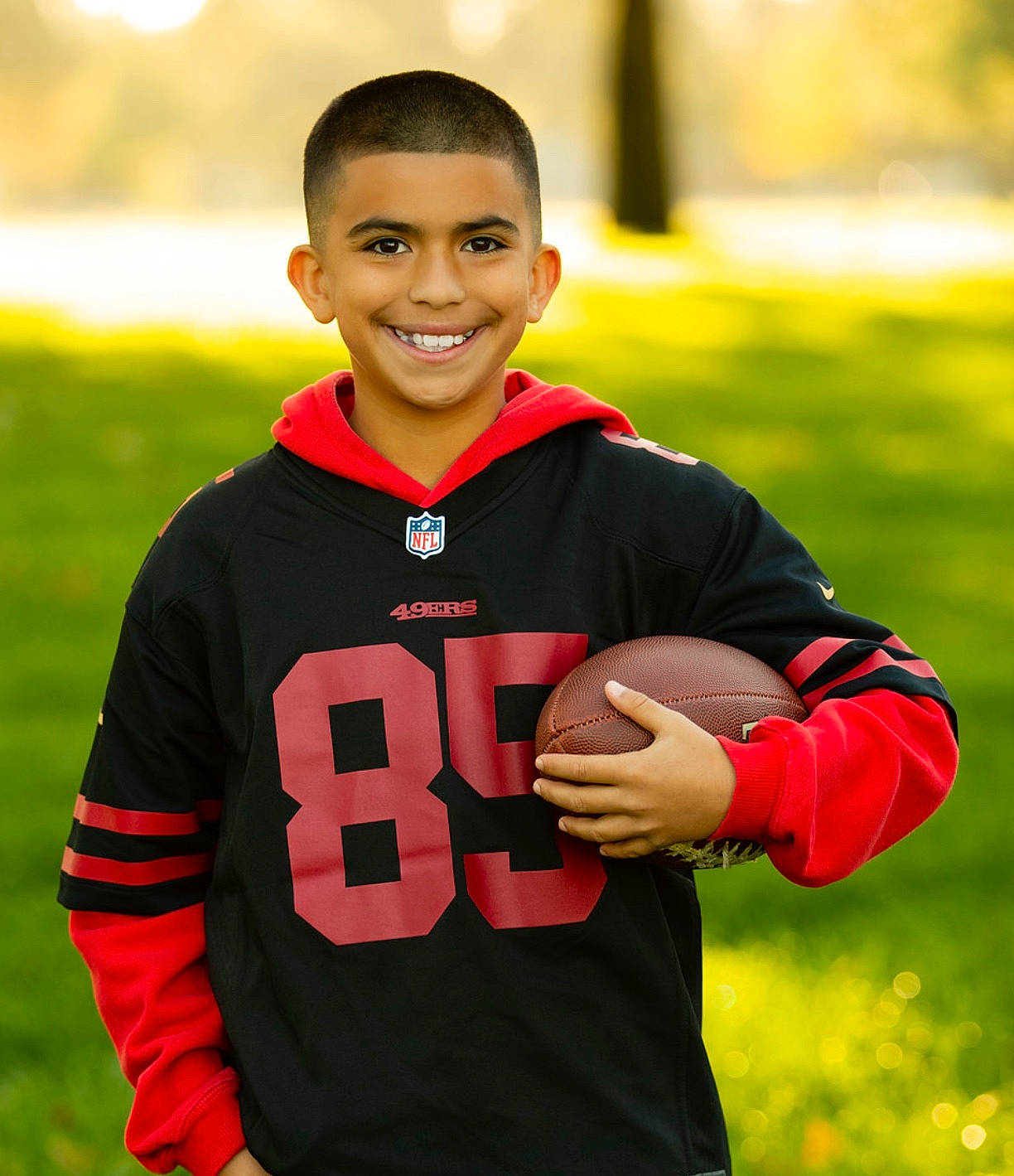 Adan is registered to the contest to win money with this photo: child, jersey, joy, outerwear, person, player, sleeve, smile, sportswear, team_sport, youth