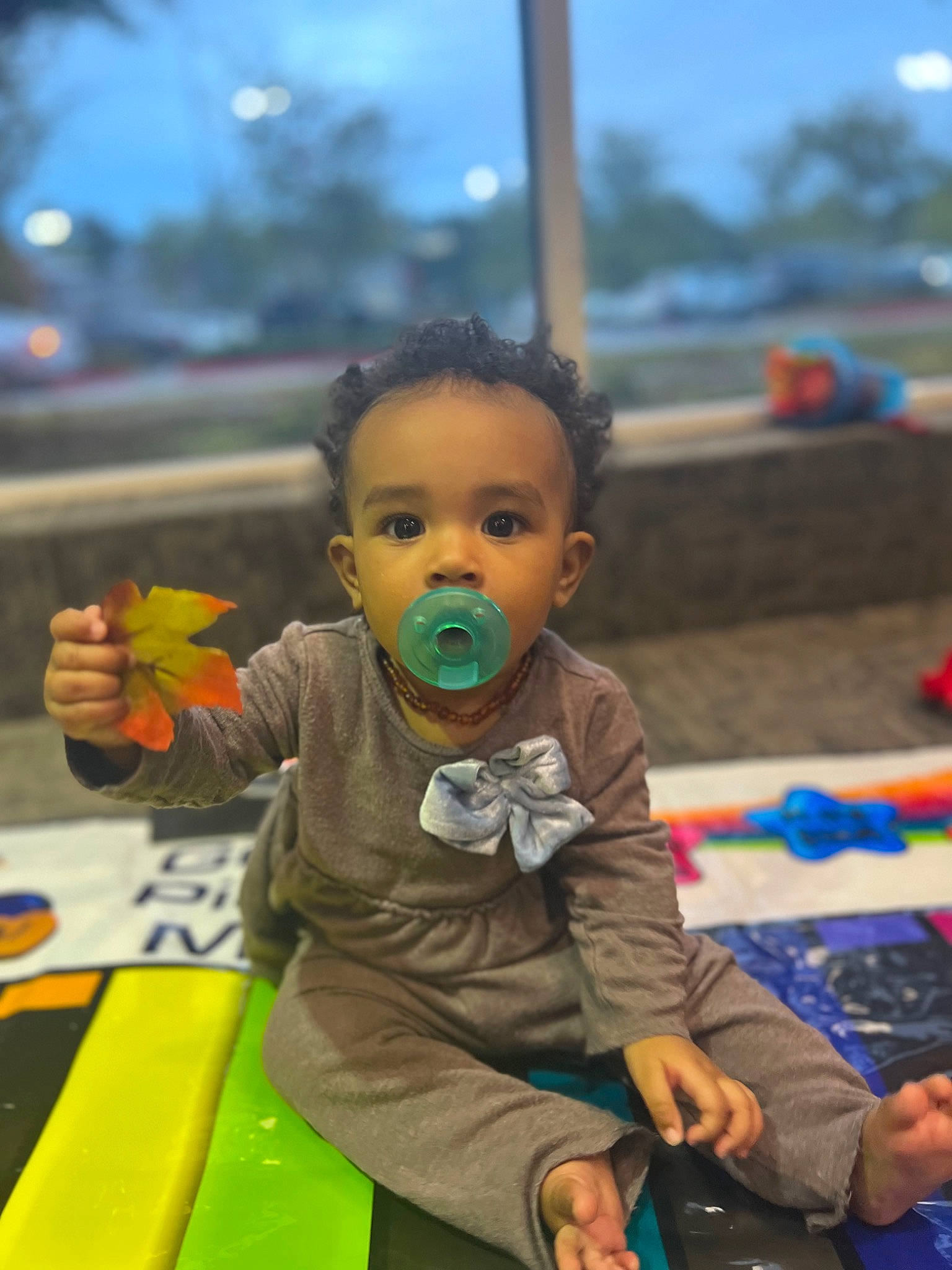 Ariah joined the competition — help win amazing prizes! adaptation, baby, child, event, facial_expression, flooring, fun, happy, kindergarten, leisure, person, play, public_space, recreation, room, sitting, skin, sky, toddler, travel