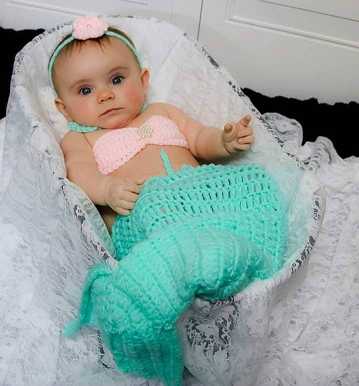 Adilynn is registered to the contest to win money with this photo: aqua, baby, baby_products, baby_toddler_clothing, blanket, child, crochet, dress, hair_accessory, knitting, lace, outerwear, pattern, person, pink, product, skin, textile, toddler, turquoise