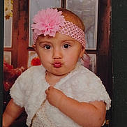 Sativa joined the competition — help win amazing prizes! baby, big_eyes, child, chubby_cheeks, cute, dress, fashion_accessory, hand, headband, indoor, photograph, pink_flower, portrait, pucker_lips, sitting, studio_backdrop, toddler, white_cardigan, window, wood_frame