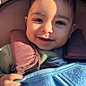 Faivish is registered to the contest to win money with this photo: baby, babywearing, blanket, child, closeup, clothing, cozy, cute, face, hand, happy, harness, infant, person, portrait, shadow, smile, sunlight, warm, young