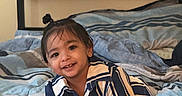 Faivish joined the competition — help win amazing prizes! toddler, child, smiling, bed, striped_shirt, crawling, indoor, hair_tie, happy, person, cute, young_child, home, plaid_bedspread, casual_clothing, portrait, baby, fun, comfort, playful
