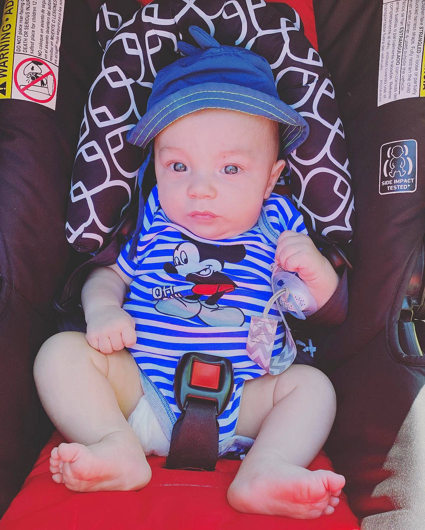 Jakobe is registered to the contest to win money with this photo: baby, baby_products, baby_toddler_clothing, child, hat, headgear, person, product, sitting, skin, toddler