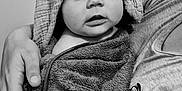 Lyzéa a rejoint le concours — aidez-le/la à gagner de superbes lots ! arm, baby, black_and_white, blanket, caring, child, curious, eyes, fabric, face, hand, holding, hood, indoor, mouth, person, portrait, skin, texture, towel