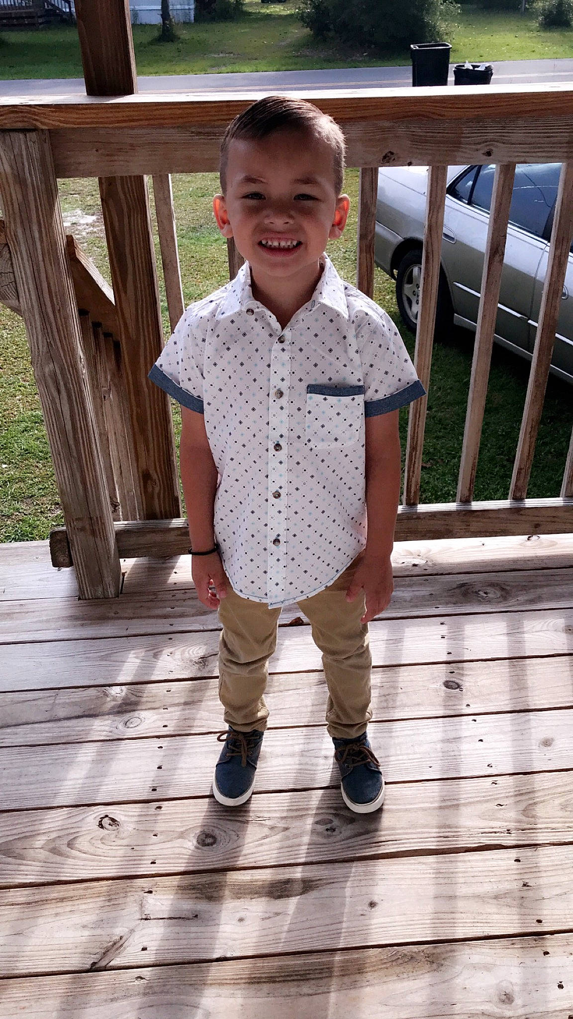 Adriel is registered to the contest to win money with this photo: child, child_model, footwear, joy, outerwear, person, shoe, sleeve, smile, standing, t_shirt, toddler