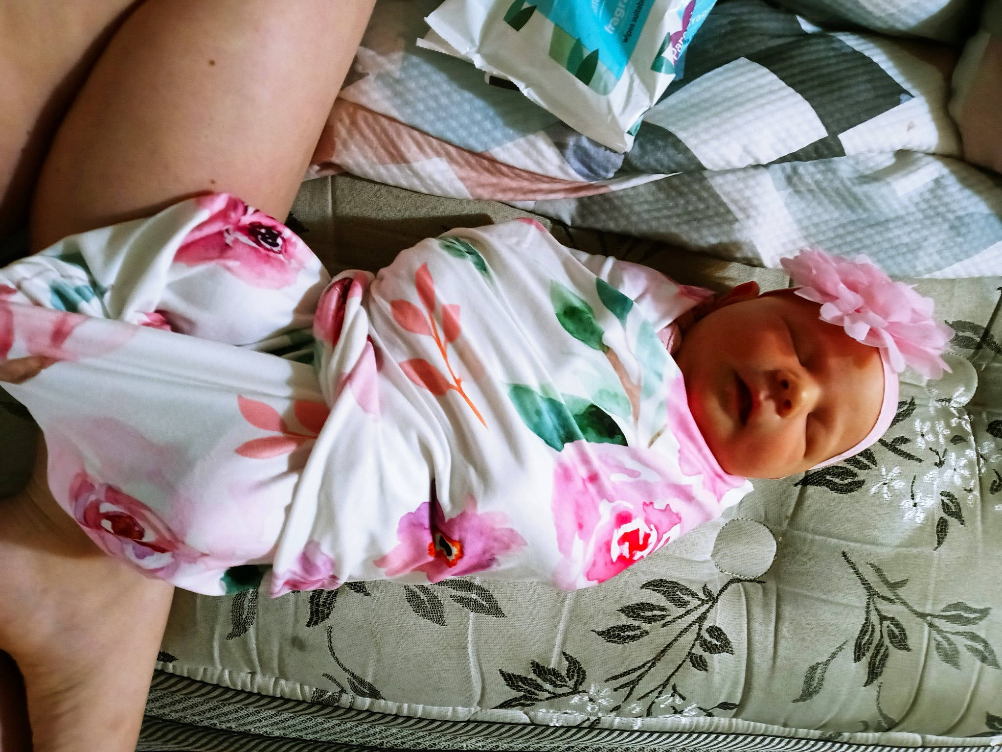 Laycie is registered to the contest to win money with this photo: arm, baby, baby_toddler_clothing, comfort, facial_expression, finger, head, headwear, human_body, human_leg, linens, pattern, person, pink, skin, sleeve, textile, thigh, toddler, tree