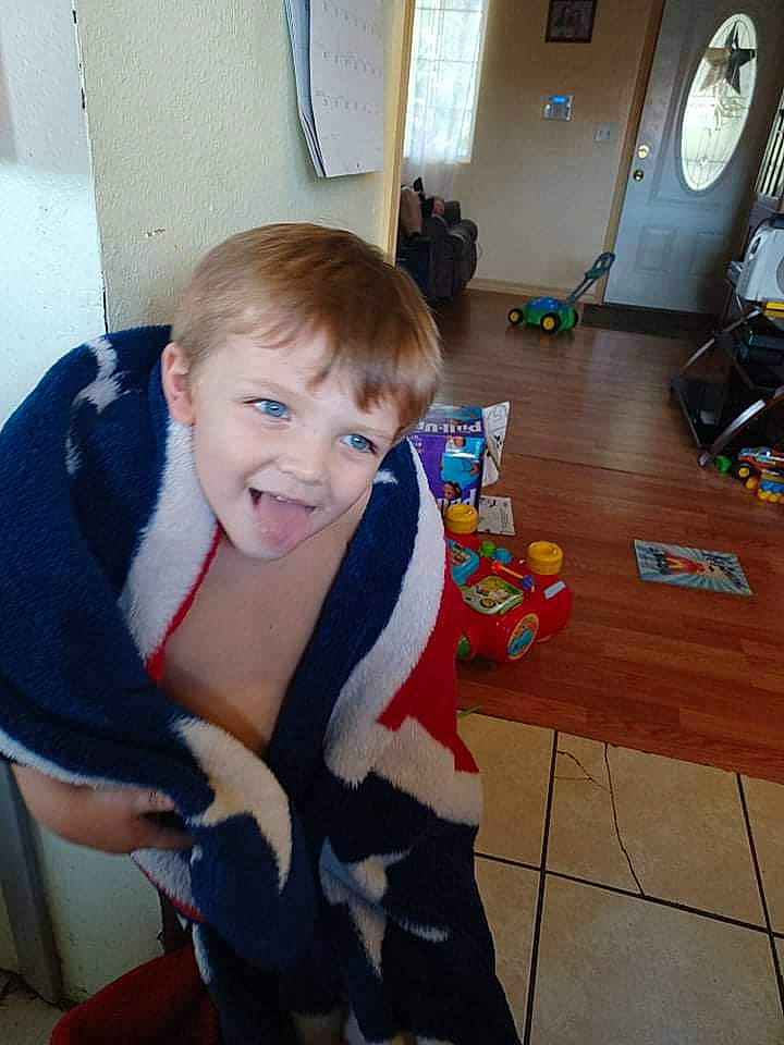 Karsen joined the competition — help win amazing prizes! chair, child, electric_blue, floor, flooring, fun, fur, furniture, hardwood, joint, living_room, mechanical_fan, person, play, room, sitting, smile, standing, t_shirt, toddler