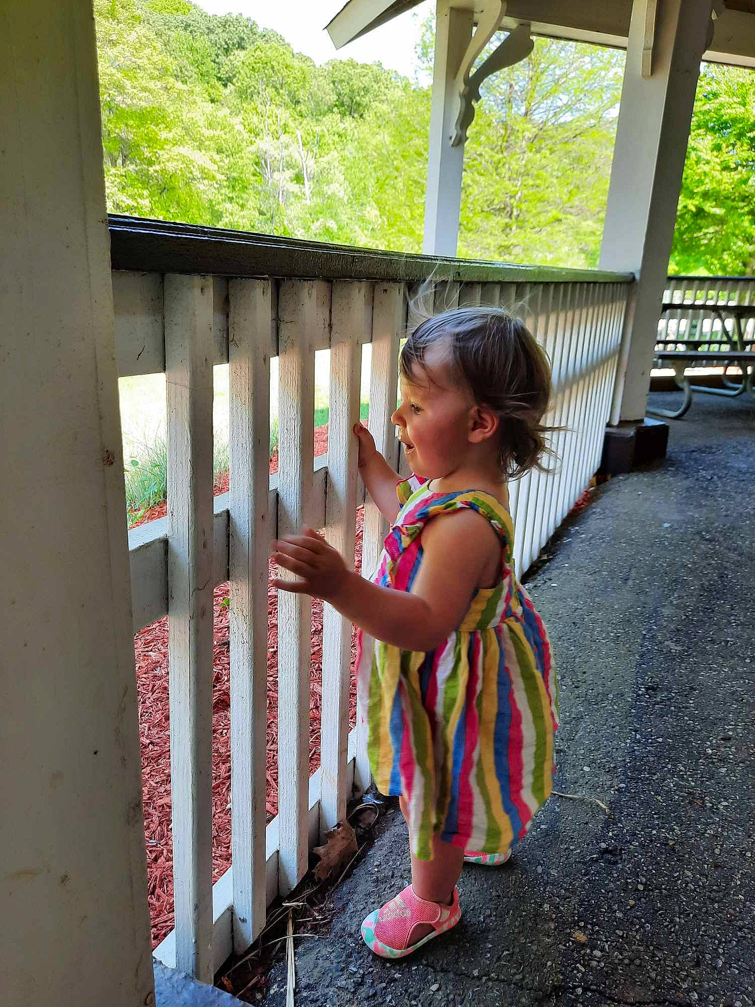 Aliyah joined the competition — help win amazing prizes! child, fence, fun, grass, handrail, happy, house, landscape, leisure, magenta, person, plant, recreation, sandal, sitting, toddler, tourism, travel, tree, vacation