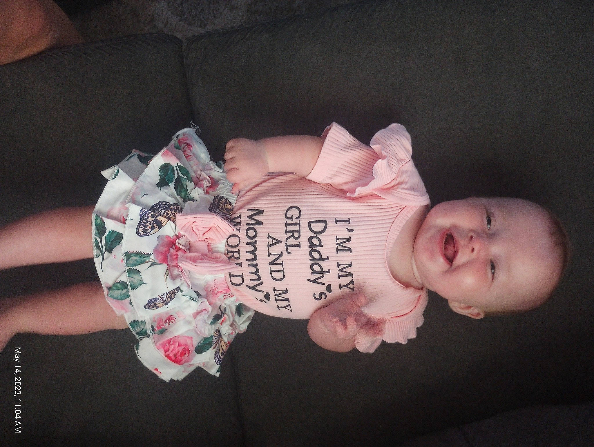 Cheryl is registered to the contest to win money with this photo: arm, baby, baby_products, baby_toddler_clothing, cheek, child, dress, eyelash, fashion_accessory, flesh, happy, human_body, human_leg, nail, pattern, person, pink, skin, sleeve, toddler