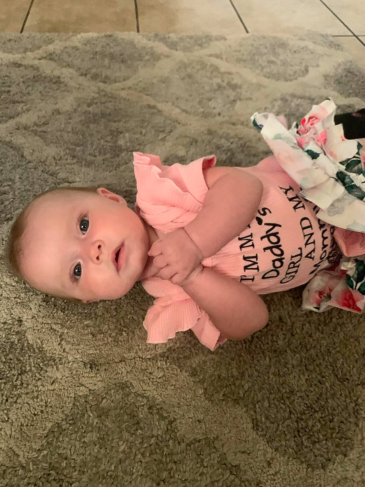Cheryl is registered to the contest to win money with this photo: baby, baby_toddler_clothing, barefoot, child, fawn, floor, flooring, foot, fun, grass, hat, headgear, human_leg, knee, mouth, person, sitting, skin, sock, thigh