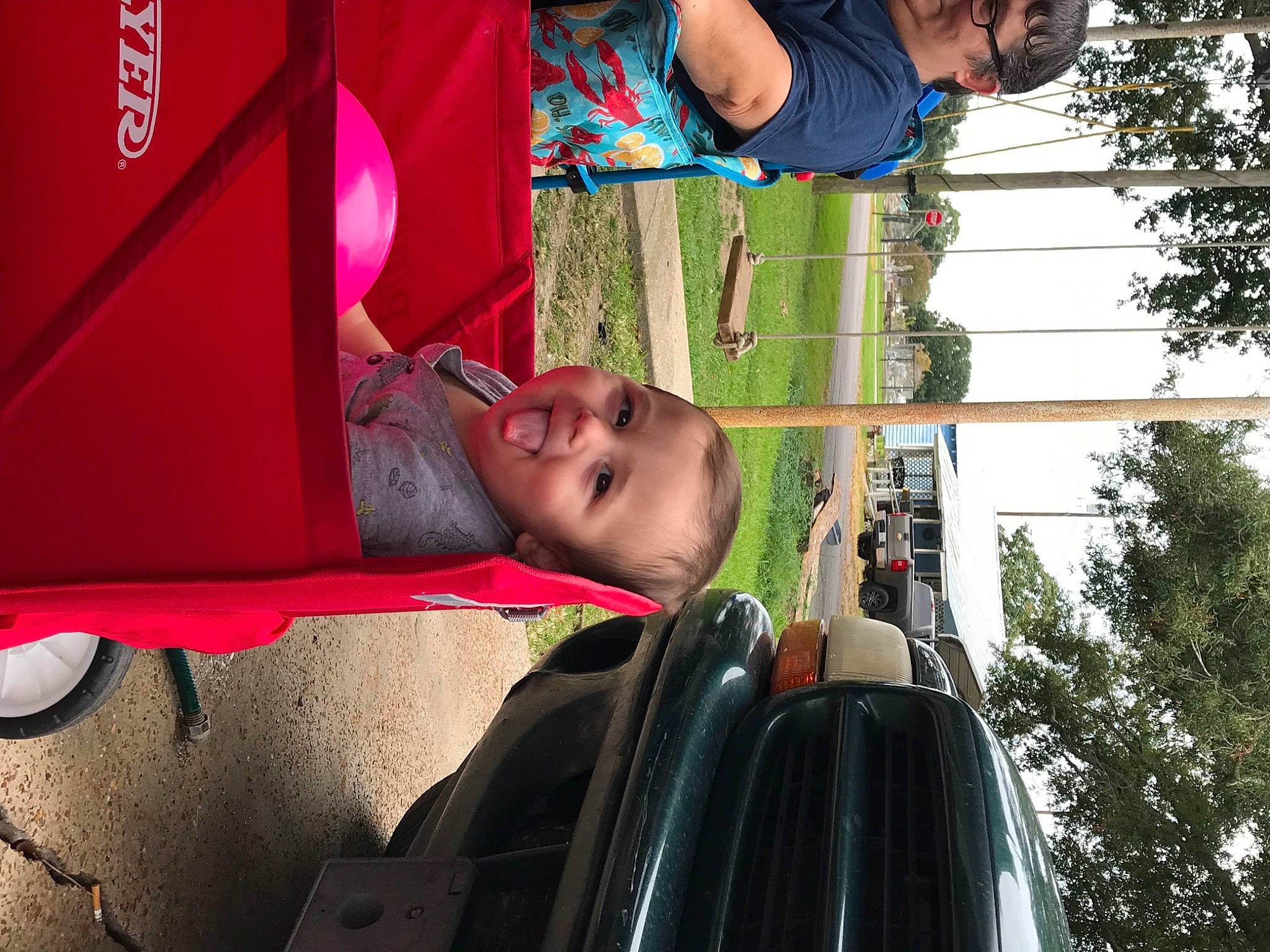 Zander joined the competition — help win amazing prizes! automotive_design, automotive_exterior, automotive_tire, eyewear, fun, grass, green, happy, leisure, motor_vehicle, person, plant, public_space, red, sky, smile, t_shirt, tints_and_shades, toddler, tree