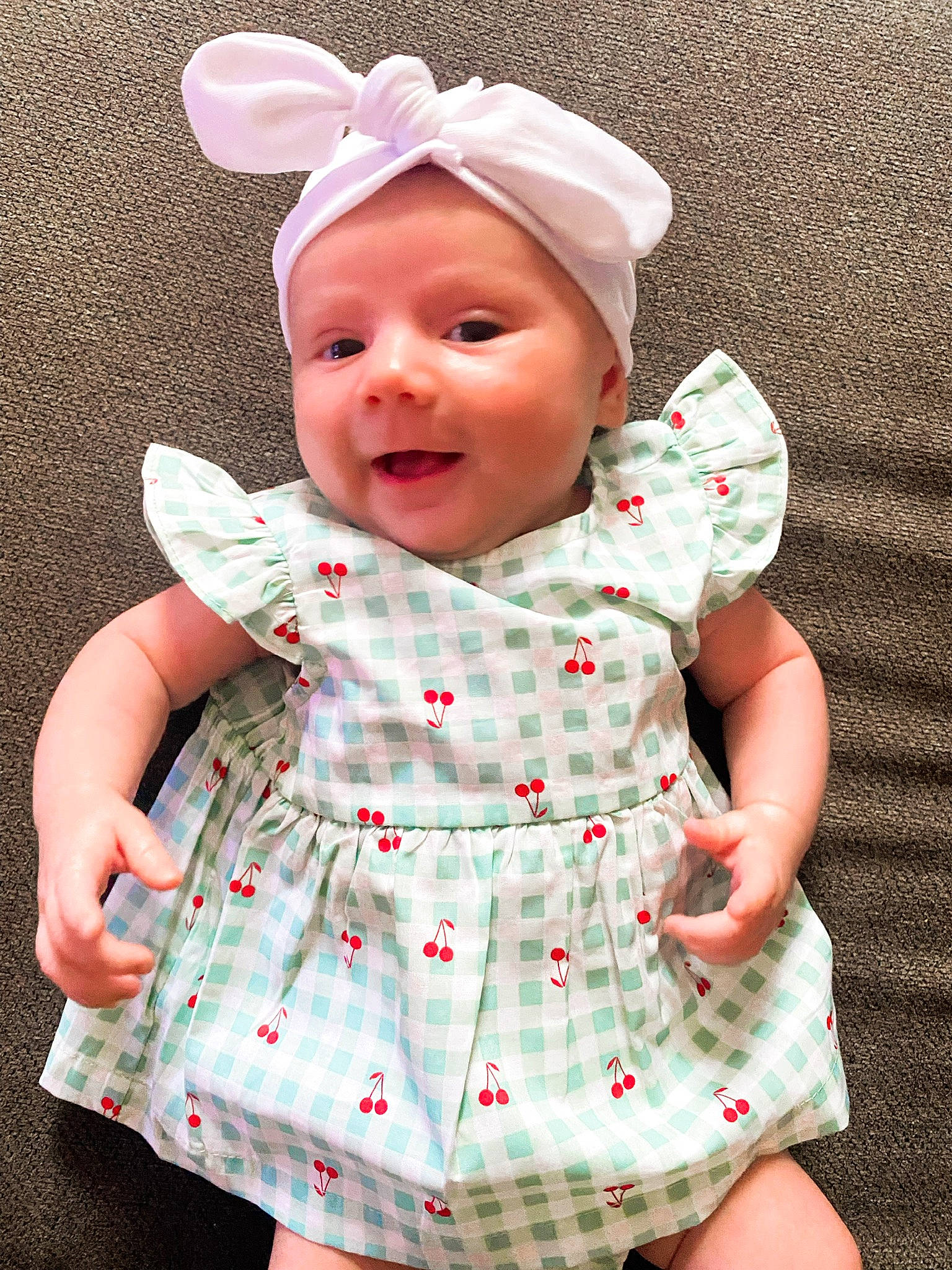 Myah is registered to the contest to win money with this photo: baby, baby_toddler_clothing, cap, child, collar, day_dress, dress, facial_expression, green, happy, headwear, lip, one_piece_garment, outerwear, person, pink, skin, sleeve, smile, textile