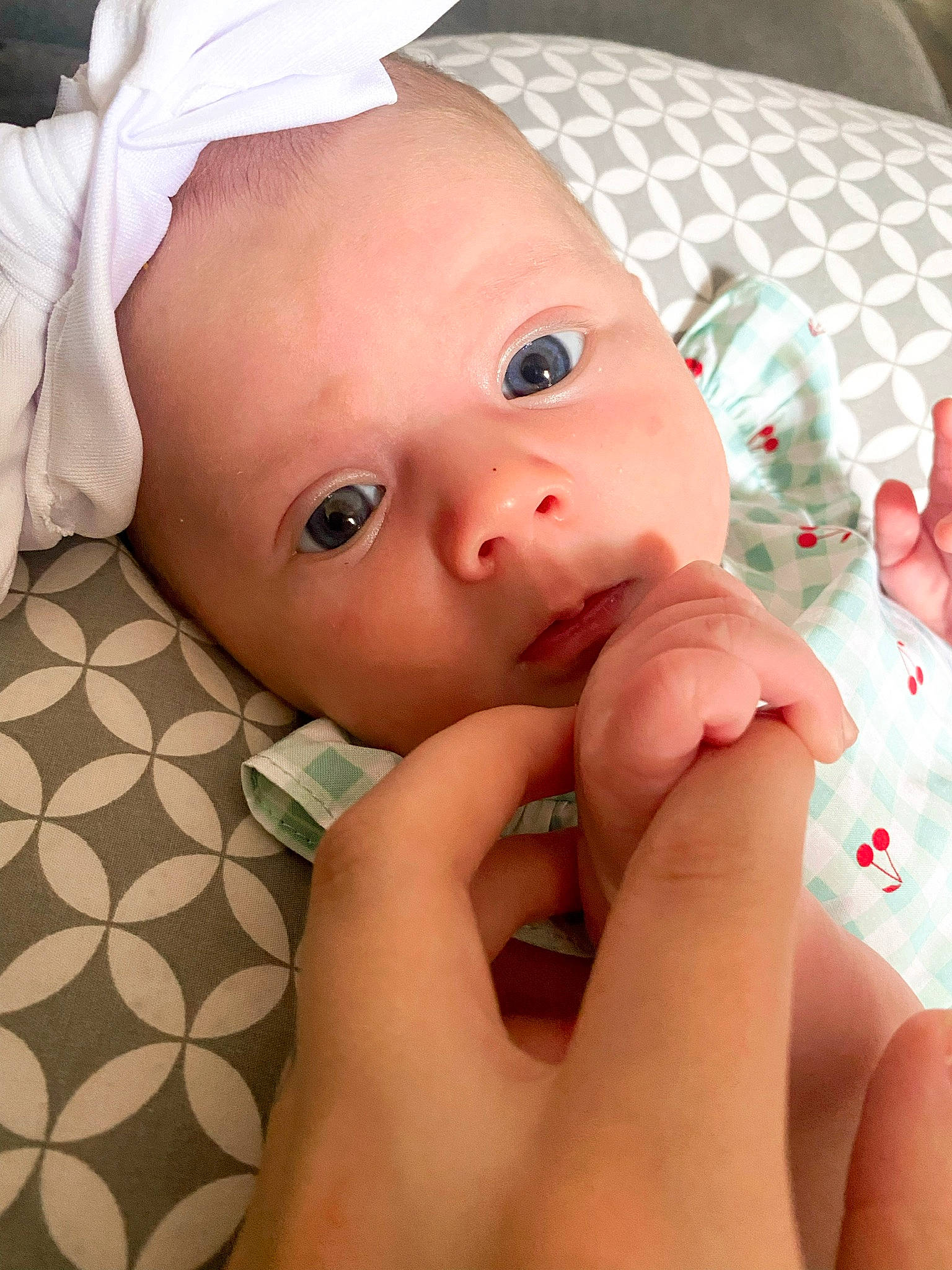 Myah is registered to the contest to win money with this photo: baby, baby_toddler_clothing, cheek, child, close_up, dress, eyelash, finger, gesture, grass, hand, happy, lip, mouth, nail, nose, person, skin, thumb, toddler