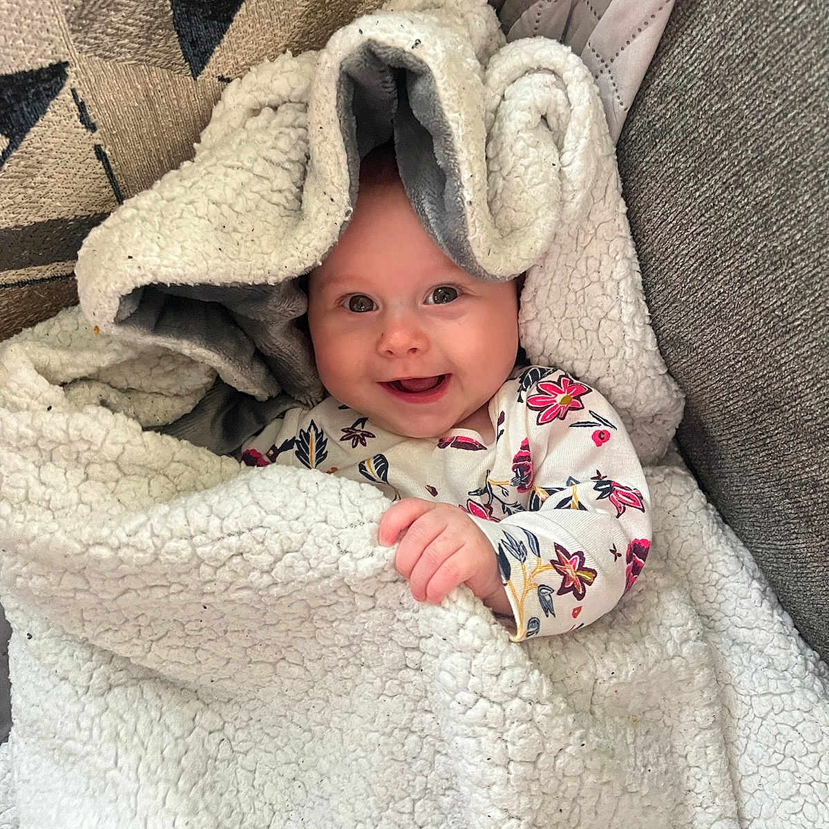 Austin is registered to the contest to win money with this photo: baby, blanket, clothing, face, happy, hat, head, hood, newborn, person, photography, portrait, quilt, smile, towel