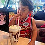 Shyloe joined the competition — help win amazing prizes! arm, beverage, casual, child, chocolate_syrup, cute, diner, food, happy, indoor, milkshake, person, red_jersey, short_hair, sitting, smile, straw, table, tattoo, whipped_cream