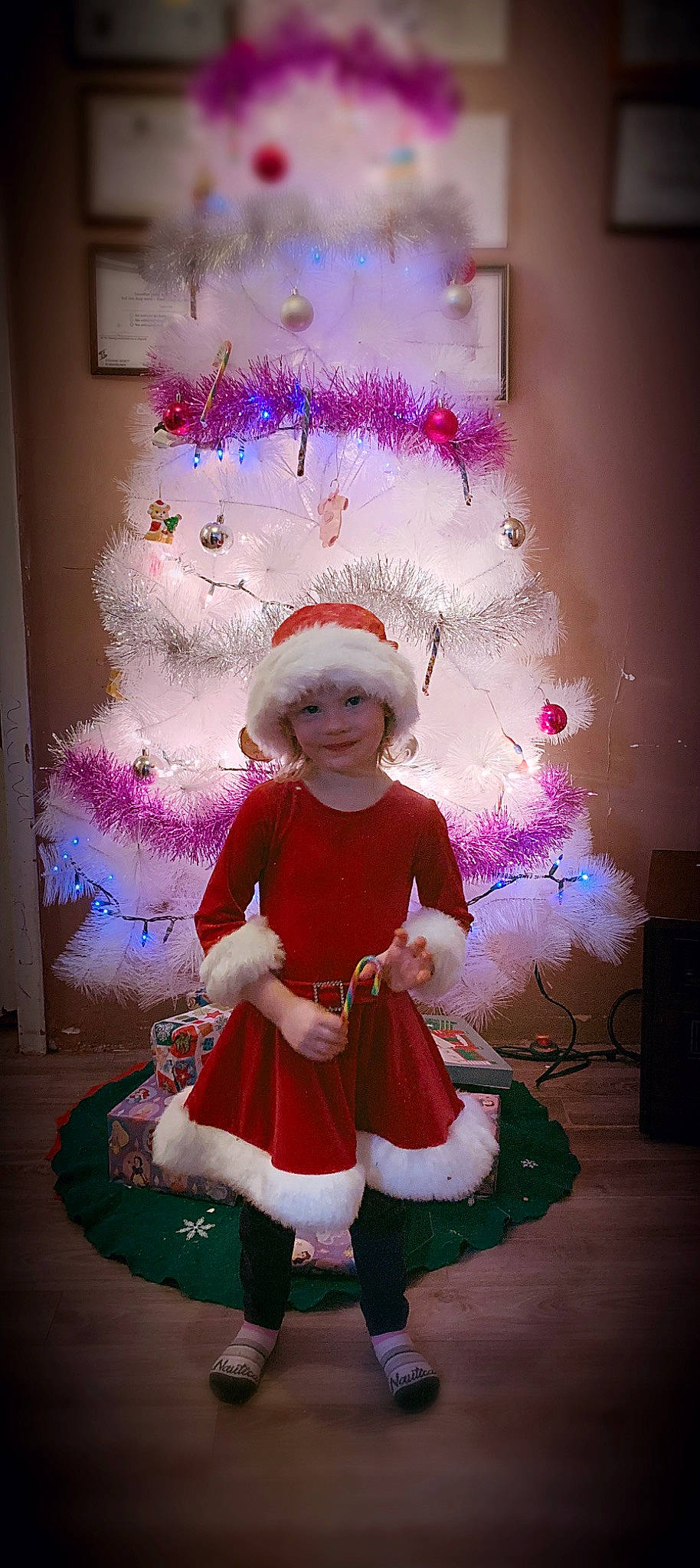 Kiera is registered to the contest to win money with this photo: child, christmas, christmas_decoration, christmas_eve, christmas_tree, costume, fictional_character, headwear, holiday, joy, person, pink