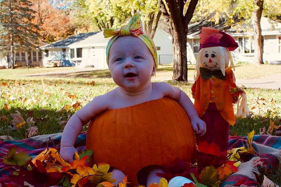 Hadley is registered to the contest to win money with this photo: botany, calabaza, community, cucurbita, facial_expression, fun, gourd, grass, happy, leaf, orange, people, people_in_nature, person, photograph, plant, pumpkin, smile, tree, winter_squash