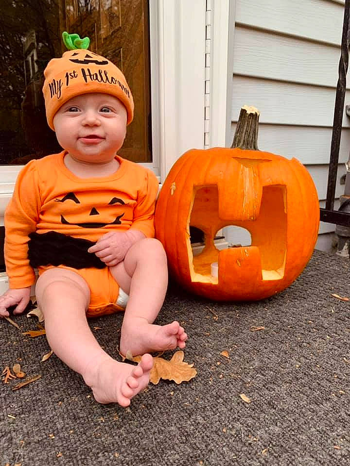 Hadley joined the competition — help win amazing prizes! baby_toddler_clothing, calabaza, cucurbita, face, fruit, gourd, grass, happy, head, headwear, jack_o_lantern, orange, person, plant, pumpkin, shorts, squash, toddler, tree, vegetable