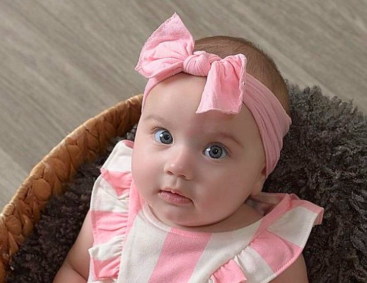 Oaklynn is registered to the contest to win money with this photo: baby, baby_toddler_clothing, cap, cheek, child, costume_hat, eyelash, face, fashion_accessory, hair_accessory, happy, headband, headgear, headpiece, headwear, lip, magenta, person, pink, sleeve