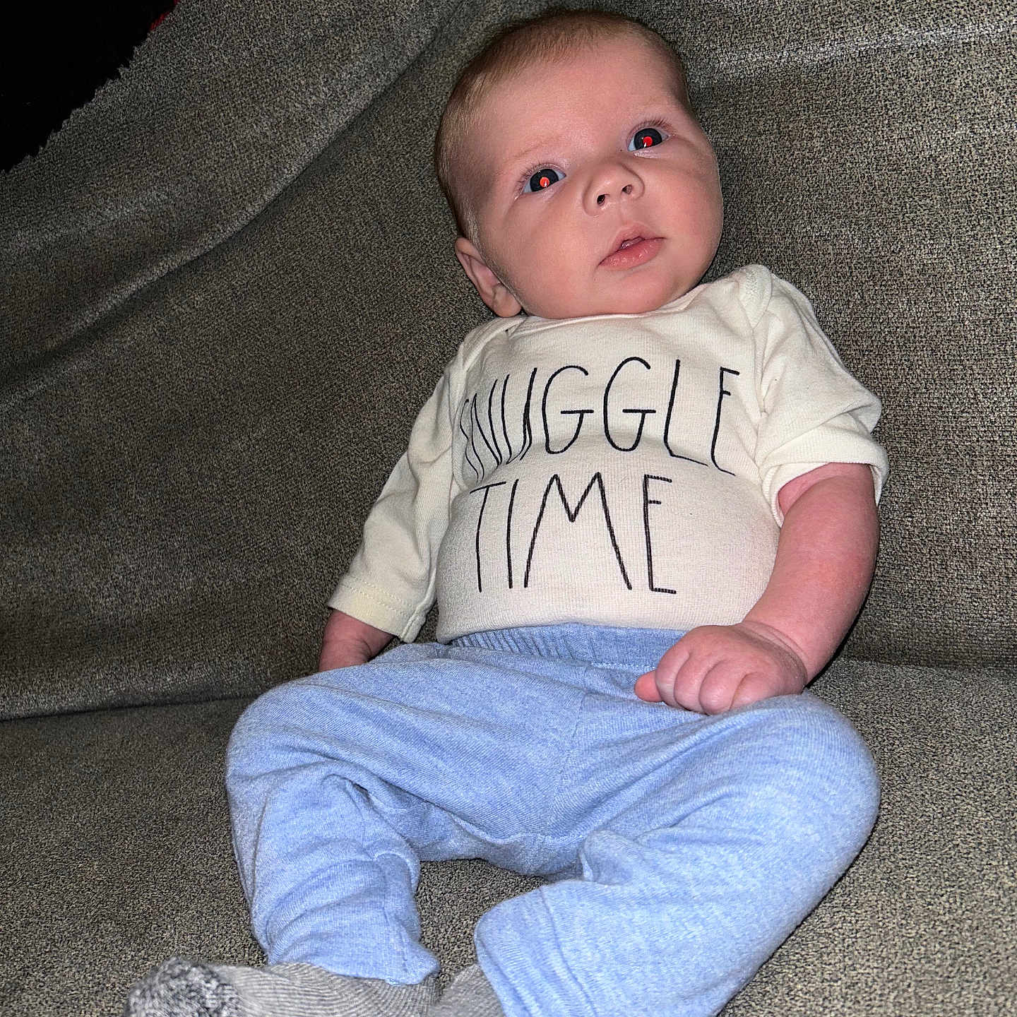 Nakoda is registered to the contest to win money with this photo: baby, chair, clothing, couch, cushion, face, footwear, furniture, head, homedecor, hosiery, jeans, pants, person, photography, portrait, shoe, sitting, sock, t_shirt