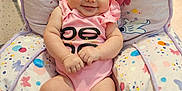 Alaina is registered to the contest to win money with this photo: baby, infant, child, pink_onesie, smiling, cushion, butterfly_pattern, indoor, toy_car, carpet, happy, chubby, seat, cute, person, skin, furniture, room, playroom, comfortable