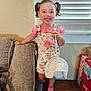 Juliette joined the competition — help win amazing prizes! child, girl, smiling, indoor, pigtails, pink_clothing, floral_overall, hat, socks, couch, window_blinds, wooden_bench, diaper_box, happy, person, portrait, home, furniture, cute, playful