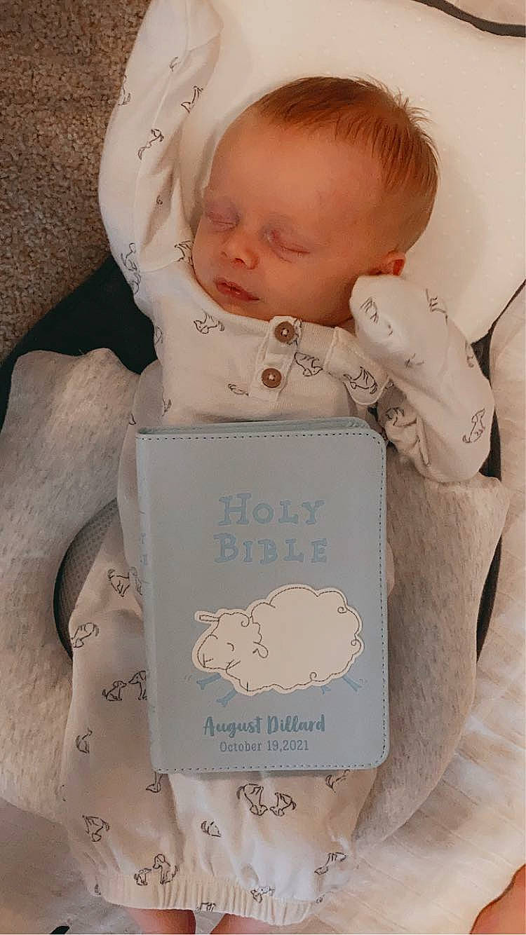 August is registered to the contest to win money with this photo: baby, baby_products, baby_sleeping, baby_toddler_clothing, bedding, bedtime, cheek, child, comfort, font, happy, home_accessories, linens, person, portrait_photography, product, room, sitting, toddler