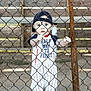 baby, child, baseball, sports, fence, chain_link_fence, bat, bench, hat, cap, outdoor, dirt, clothing, person, young_child, cute, standing, portrait, daylight, curious
