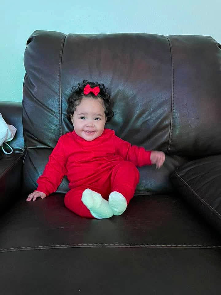 Zaylei joined the competition — help win amazing prizes! baby, baby_laughing, baby_toddler_clothing, child, comfort, couch, crawling, facial_expression, floor, human_body, joy, lap, living_room, magenta, mouth, nose, person, pink, sitting, studio_couch