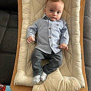 Adam a rejoint le concours — aidez-le/la à gagner de superbes lots ! baby, infant, child, blue_shirt, jeans, socks, baby_bouncer, cushion, sofa, toy, indoor, portrait, casual_clothing, baby_seat, wooden_frame, relaxed, young_child, face, person, comfort