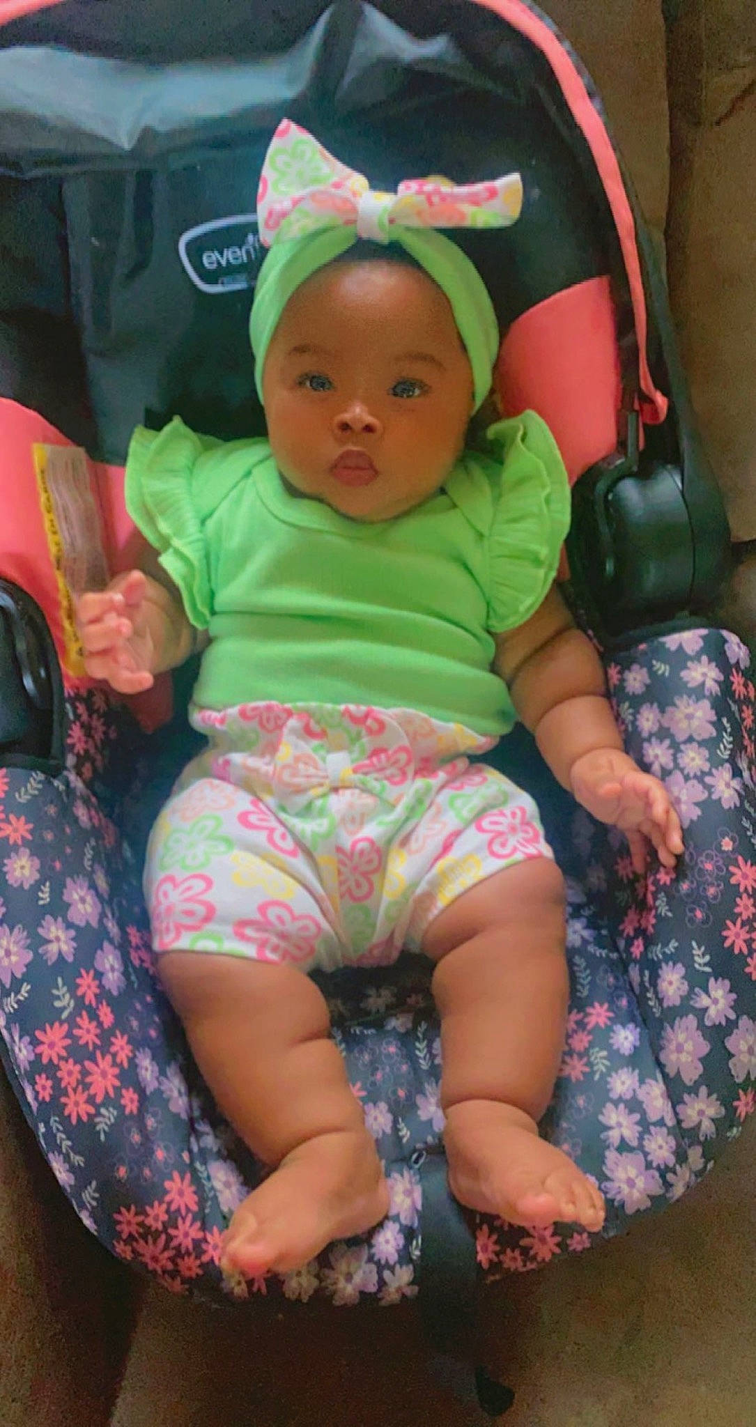 Eva Hartso is registered to the contest to win money with this photo: baby, baby_products, baby_toddler_clothing, cap, car_seat, chair, cheek, child, comfort, eye, fun, green, head, lap, person, pink, sitting, skin, sleeve, thigh