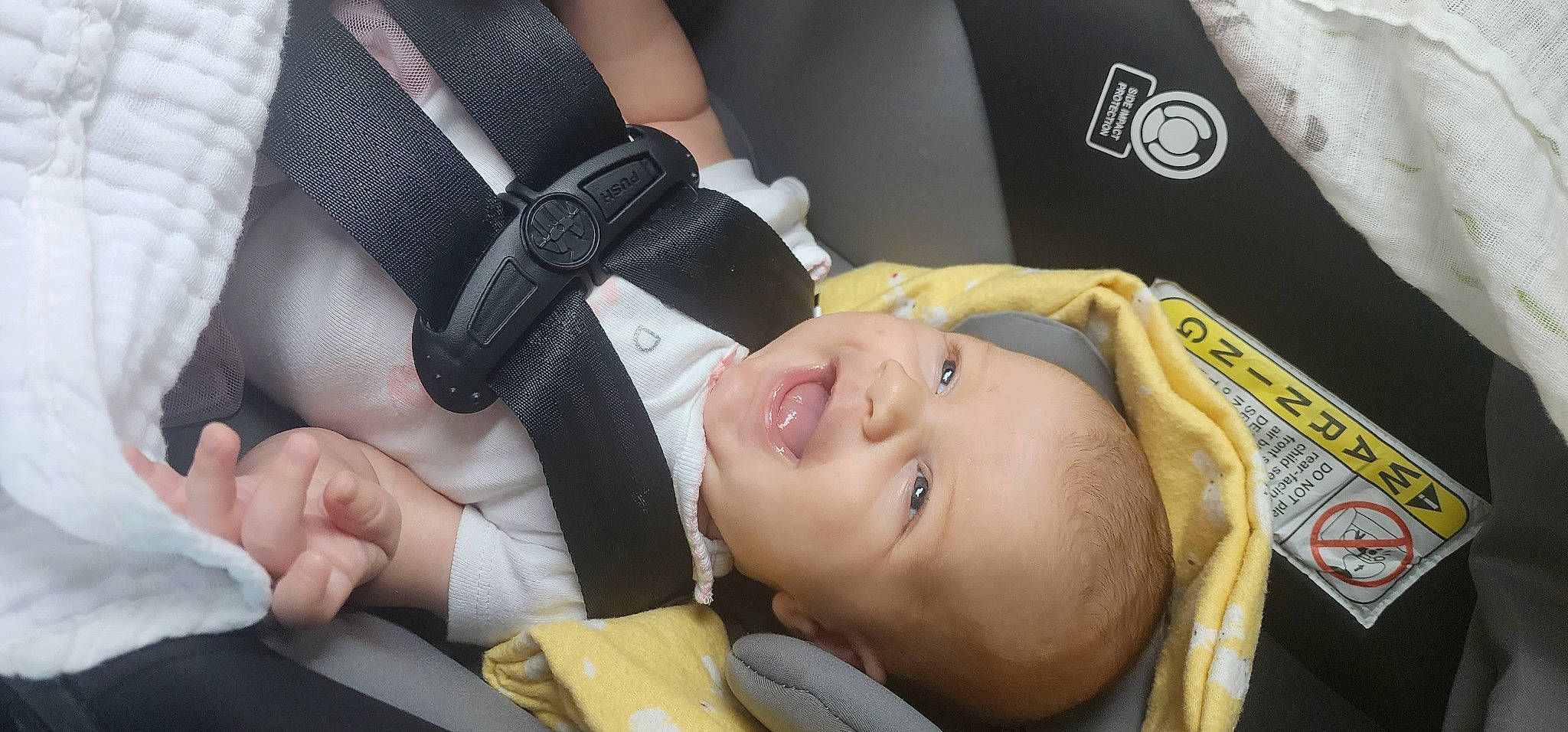 Braylee is registered to the contest to win money with this photo: auto_part, baby, baby_carriage, baby_products, car_seat, child, comfort, fashion_accessory, finger, gesture, hand, nail, person, personal_protective_equipment, product, seat_belt, smile, thumb, toddler, wrist