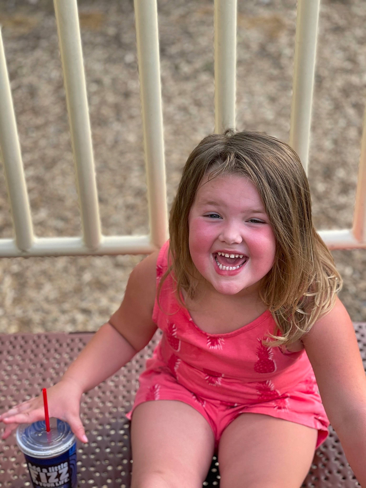 Alison joined the competition — help win amazing prizes! child, face, facial_expression, finger, fun, grass, happy, human_body, human_leg, joy, leisure, magenta, organ, person, pink, shorts, sitting, skin, smile, thigh