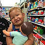 baby, ball, face, food, football, happy, head, indoors, person, photography, portrait, shelf, shop, shopping, smile, soccer, soccerball, sport, sweets, toy