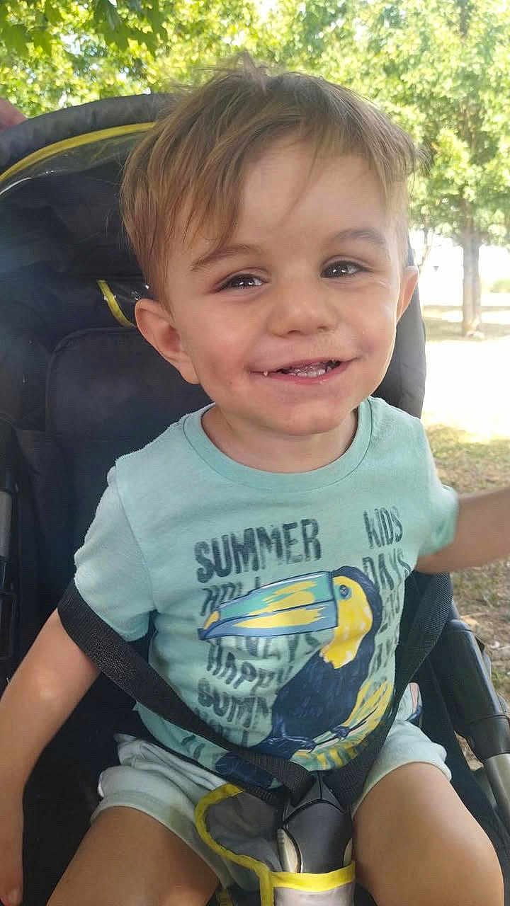 Ayden participe au concours pour gagner de l'argent avec cette photo : toddler, child, smiling, stroller, outdoor, tree, greenery, sunlight, summer, shorts, seatbelt, happy, young, casual_clothing, nature, daytime, portrait, cute, person, park