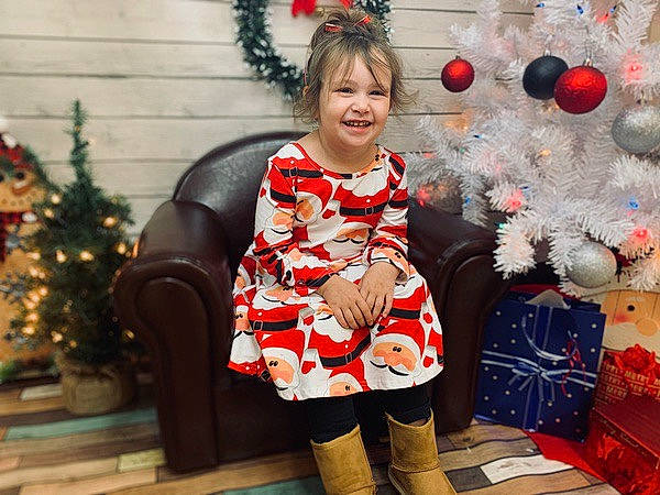 Amiyah Kay is registered to the contest to win money with this photo: christmas_decoration, christmas_ornament, christmas_tree, event, fawn, happy, head, holiday, joy, organ, ornament, pattern, person, photograph, red, sleeve, smile, snapshot, standing, textile