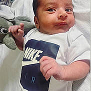 Reyansh is registered to the contest to win money with this photo: baby, blanket, child, closeup, cute, elephant_toy, expression, eyes, fabric, face, hand, indoors, infant, lying_down, newborn, nike_logo, plush_toy, skin, texture, white_onesie