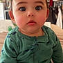 River joined the competition — help win amazing prizes! baby, child, infant, face, portrait, green_onesie, dinosaur_print, cute, rosy_cheeks, indoor, curious_eyes, sitting, young_child, clothing, person, head, expression, soft_lighting, closeup, home