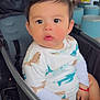 baby, child, stroller, indoor, face, curious, clothing, person, seat, bracelet, cute, casual, cafe, table, chair, expression, black_hair, skin, infant, portrait
