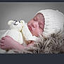 baby, sleeping, knit_hat, knit_blanket, teddy_bear, soft_toy, cozy, peaceful, infant, cute, resting, closeup, portrait, child, fluffy, warm, comfort, indoor, headwear, newborn