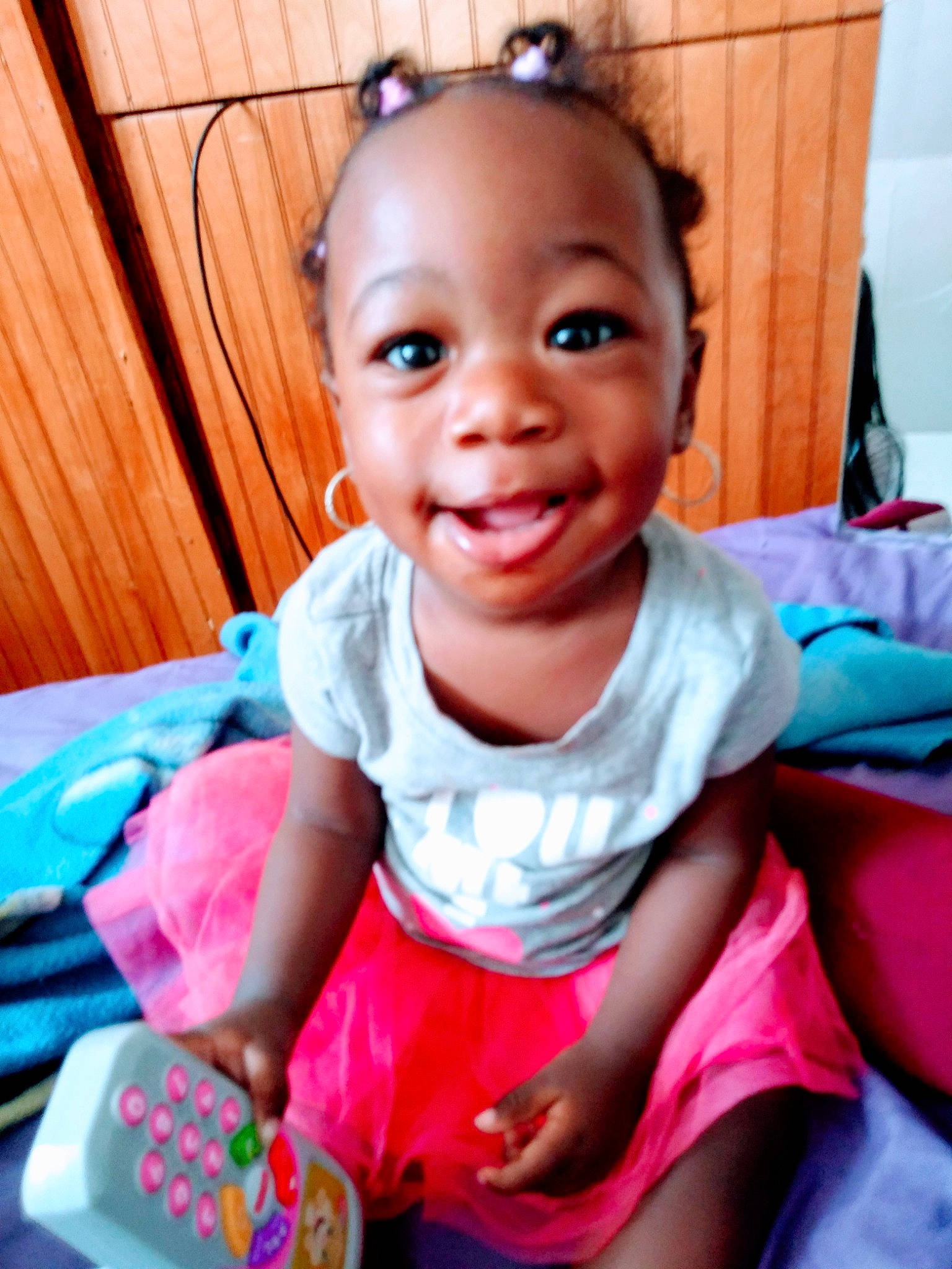 Laniya is registered to the contest to win money with this photo: baby, baby_toddler_clothing, cheek, child, face, facial_expression, fun, happy, laugh, person, pink, play, sitting, skin, smile, toddler